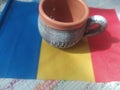 Handmade traditional Romanian objects placed on the Romanian flag and on a handmade carpet during the loom